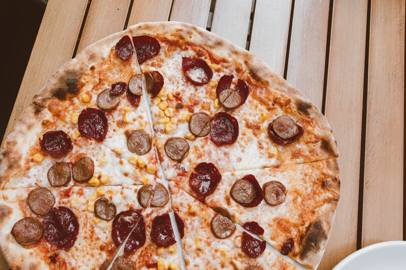 Spicy Ranch Inferno pizza with hot peppers and ranch drizzle